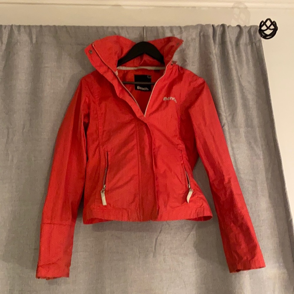 Bench pink jacket. Spring jacket. Has hood and a pocket to stuff it in.